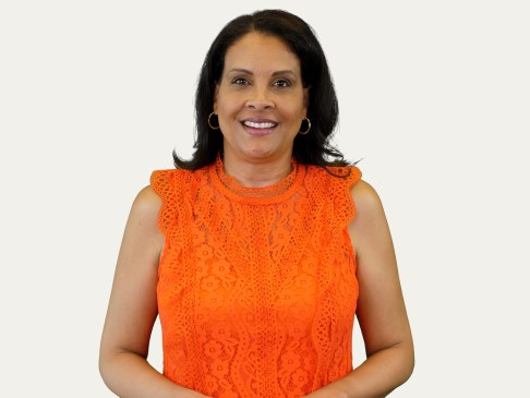 Woman in orange top against white background